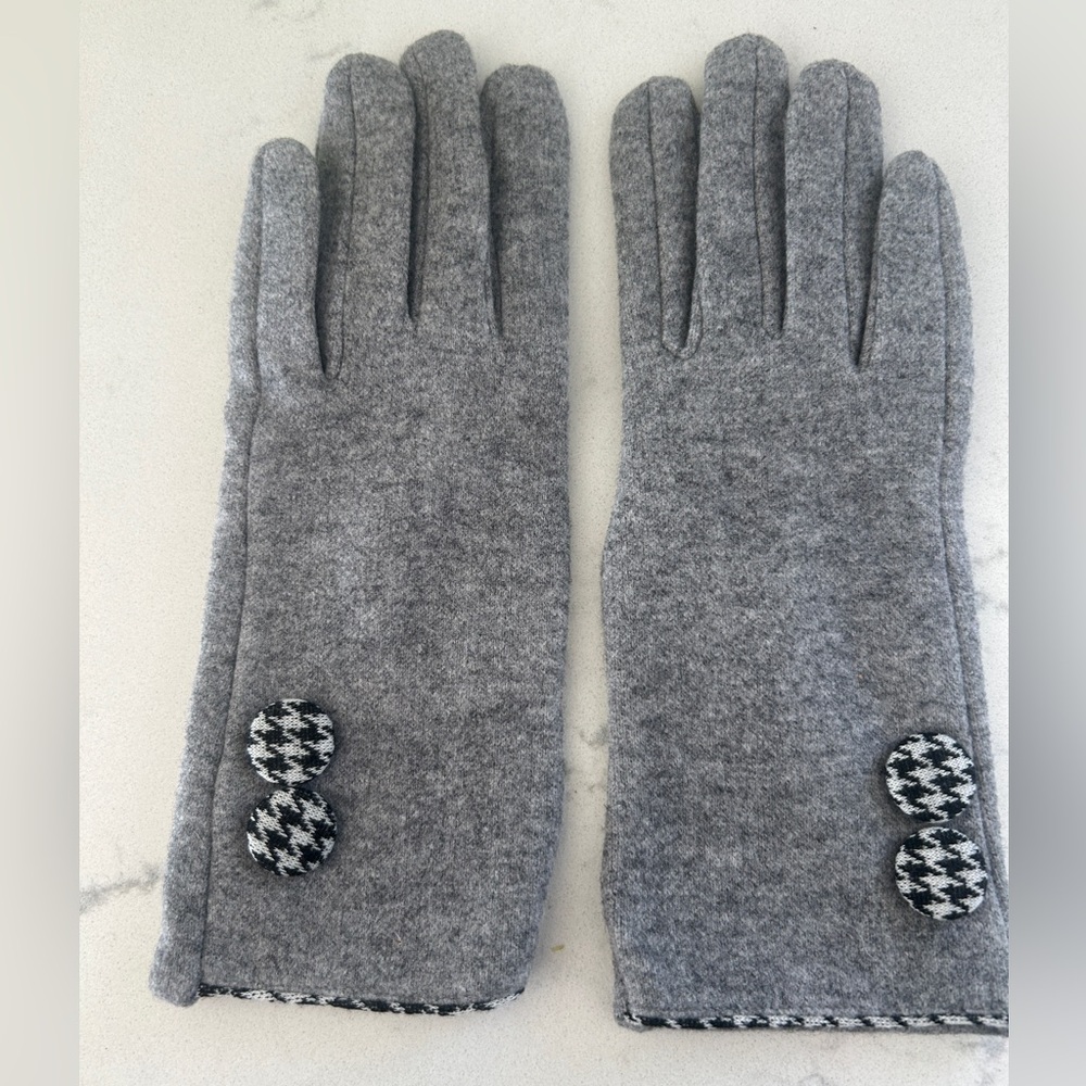 Gray gloves with black and white houndstooth buttons and touch screen fingers